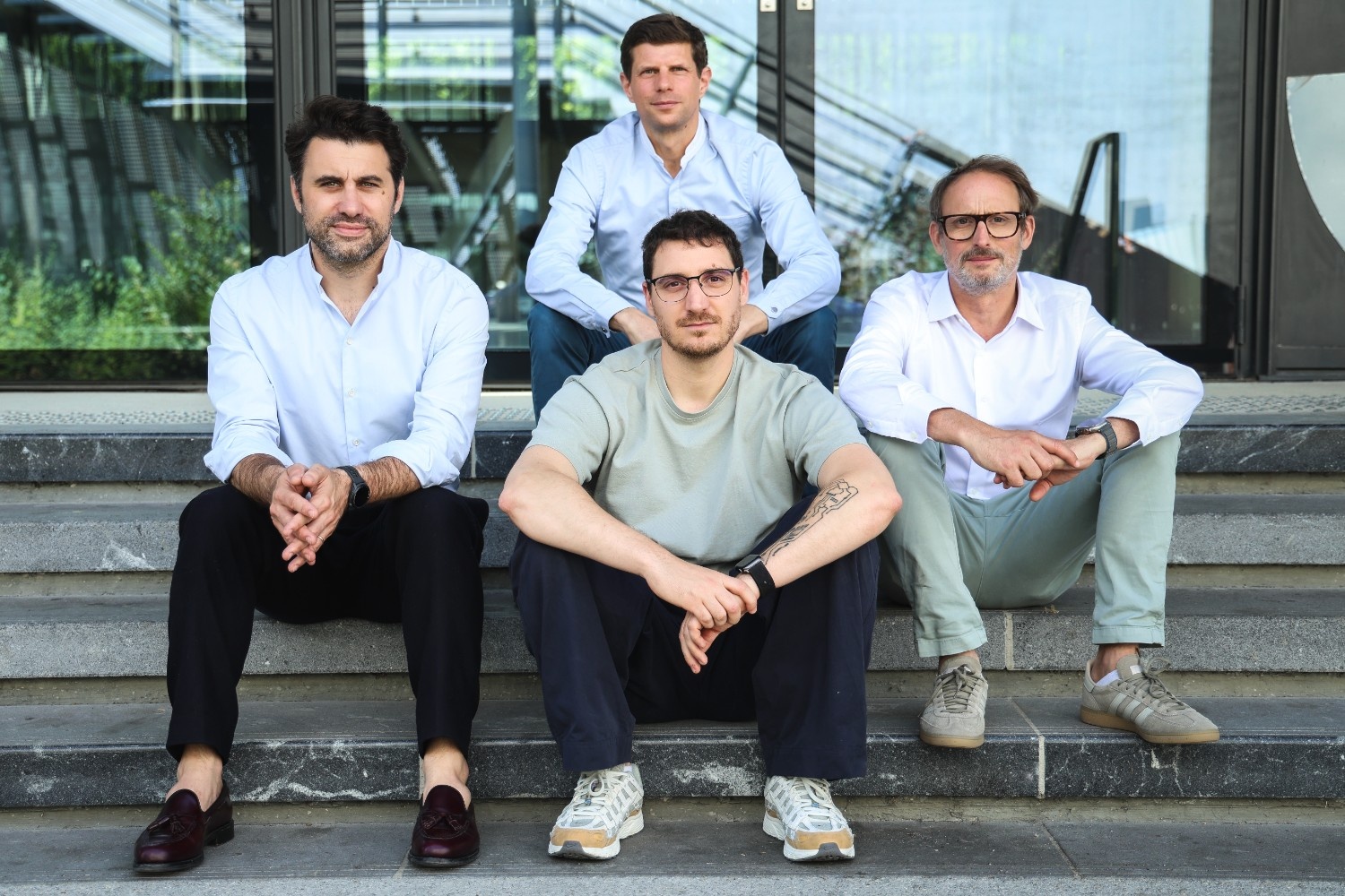 Smalk founding team sitting together on outdoor steps